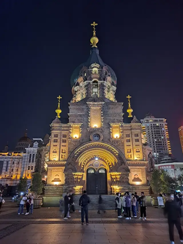 Saint Sophia Cathedral in Harbin floodlit at night, seen from the square in front of its main entrance.