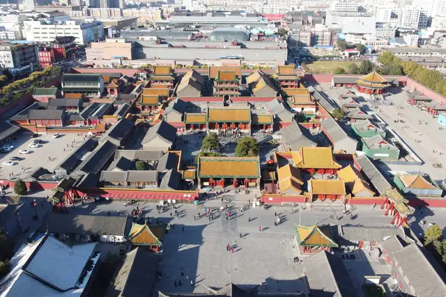 Aerial view of the Mukden Palace in Shenyang on a sunny autumn day: rows of golden-tiled halls and red walls, with the octagonal Dazheng Hall at upper right.